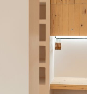 a room with a wooden shelf and a bench